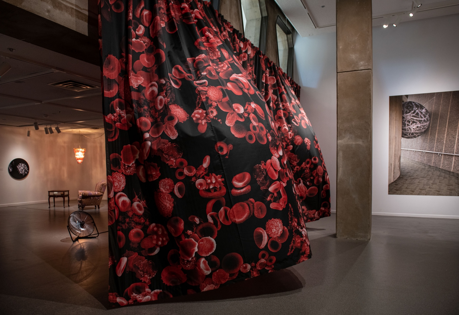 Billowing curtain made of black and red printed fabric.
